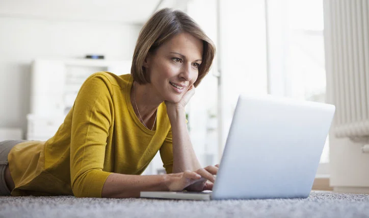 Liegende Frau am Laptop